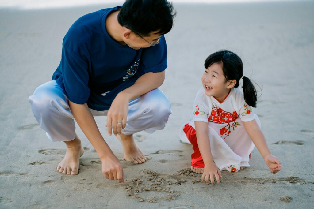 a father and daughter on the beach