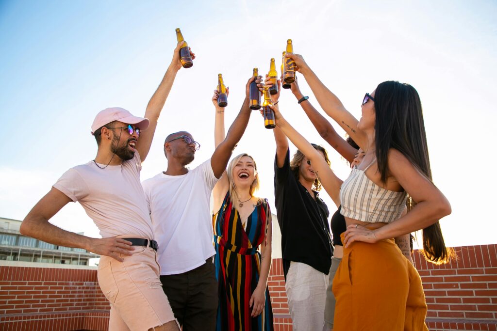 a group holding drinks up and toasting